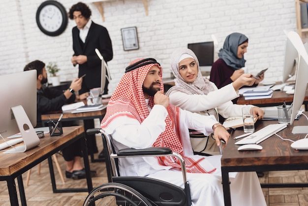 Arab Disabled Man and Woman Discuss in Office.