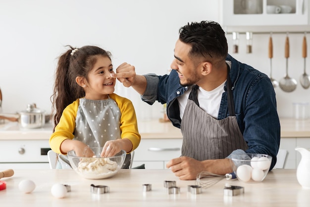 Arab Family Dad And Little Daughter Baking In Kitchen And Having Fun