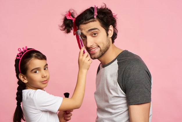 Arab Family. Little Girl Does Makeup To Father.