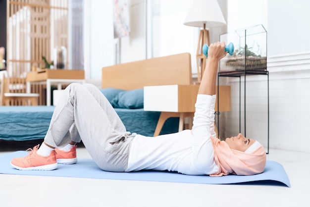 Arab woman doing gymnastics in the bedroom