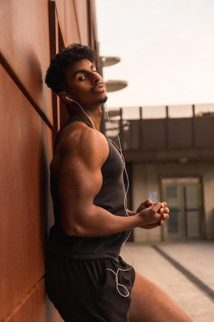 Arab young man doing sport exercises in the city pose of the strong young man