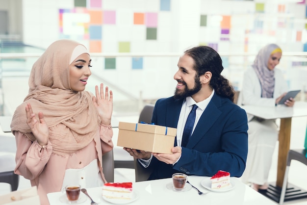 Arabian Couple Sitting in Cafe after Shopping.