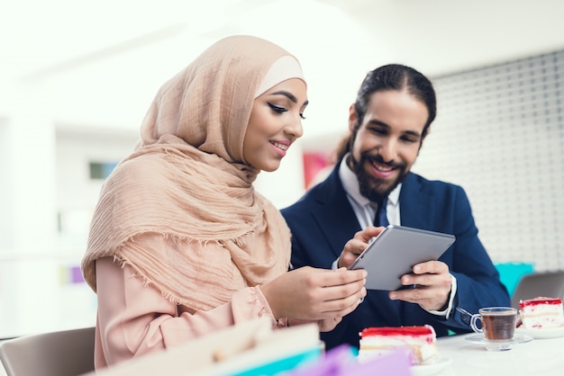 Arabian Couple Sitting in Cafe and Watch Movie.