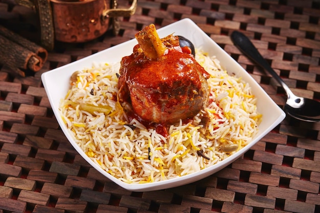 Arabian Ghoozi lamb rice biryani served in dish isolated on table side view of middle east food