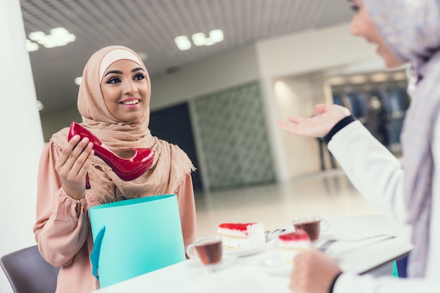 Arabian Women Sitting in Cafe in Modern Mall.