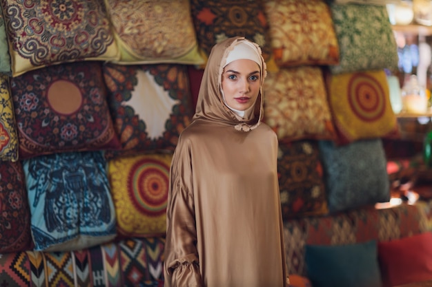 Arabian young muslim woman sitting in a cafe.