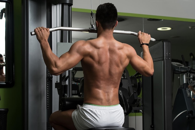 Arabic Bodybuilder Doing Heavy Weight Exercise For Back On Machine