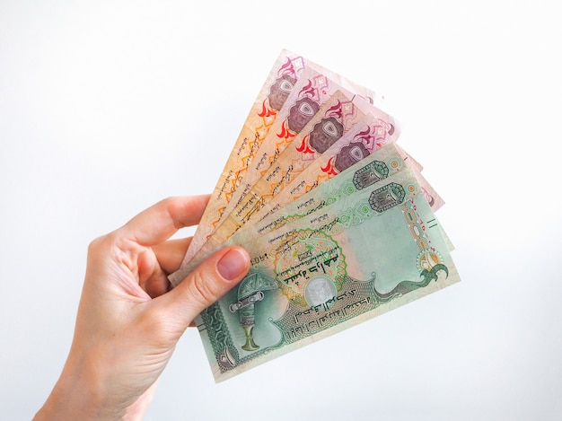 Arabic dirhams banknote fan held by a hand