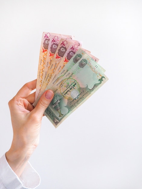 Arabic dirhams banknote fan held by a hand