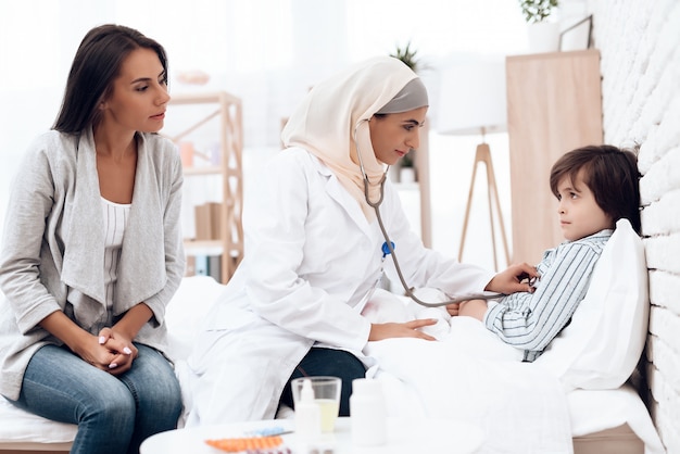 Arabic Female Doctor Examining a Little Boy