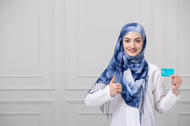 Arabic girl wrapped head in blue white hijab beautiful muslim cute young lady with credit card