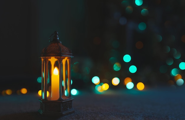 Arabic Lantern on black marble with blurry bokeh light backgroundEid decorative traditional lamps illuminated ready for the Holy season of Ramadan KareemConcept for Islamic muslim holidays celebrate