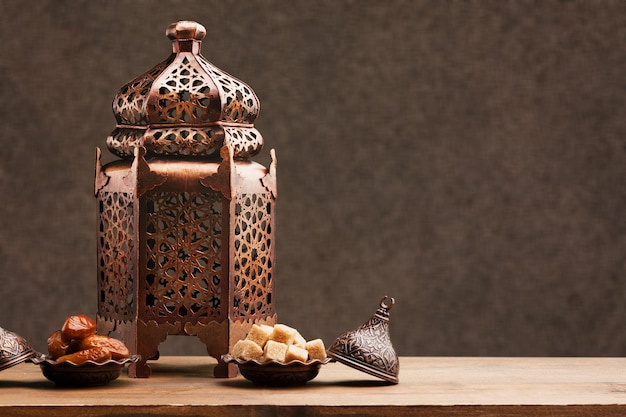 Arabic lantern with candle on table