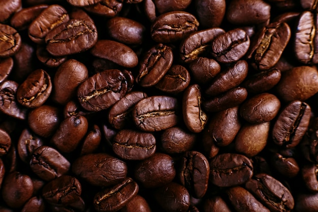 Arabica coffee beans close-up, fragrant brown background.