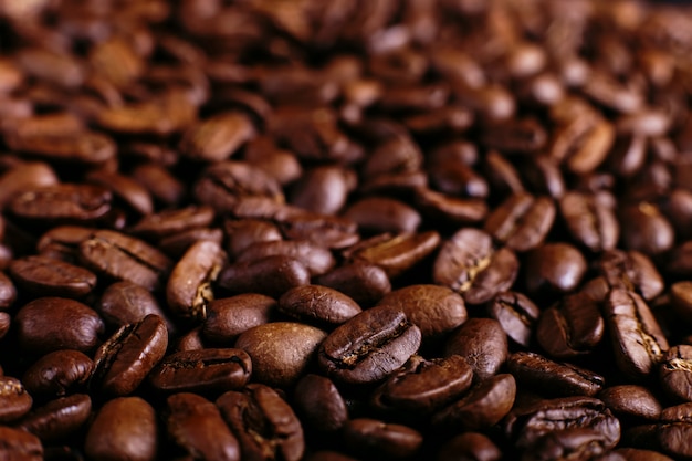 Arabica coffee beans close-up, fragrant brown background.