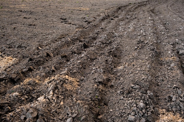 The arable field is ready for spring agricultural work plowed black soil