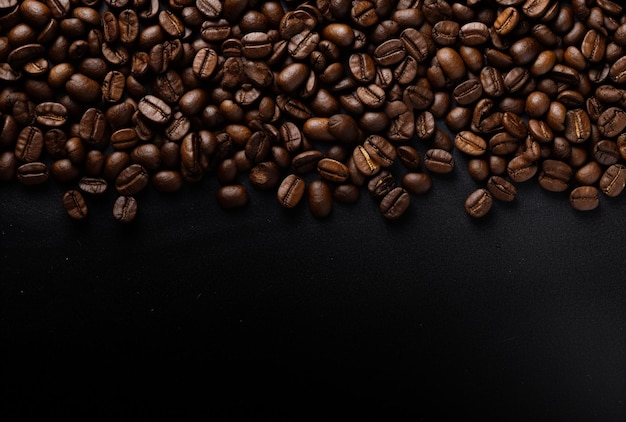 arafed coffee beans are scattered on a black surface generative ai