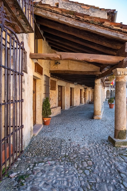 Arcades of the old city of Pedraza with its old roofs supported by stone columns Segovia Spain