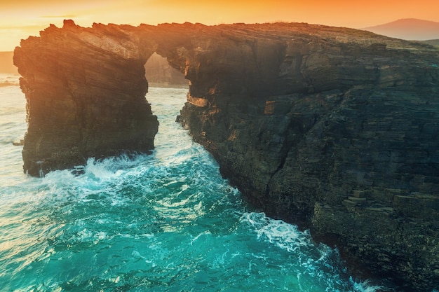 Arch in the rock Seascape in the morning Rocky sea coast at sunrise Beach Playa de Las Catedrales in Ribadeo Galicia Spain Europe