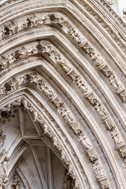 arch with figures of Gothic style cathedral in Toledo Spain