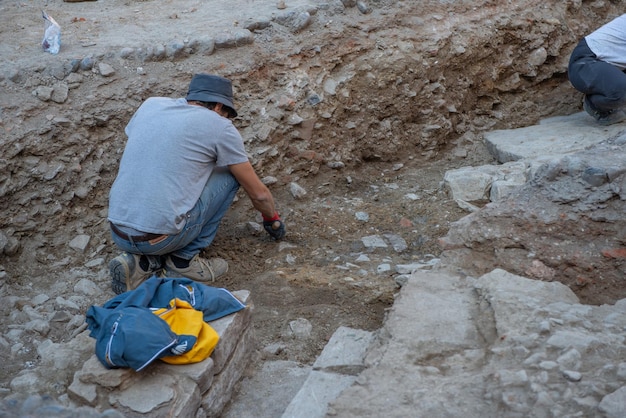 Archaeologist at work in ancient Roman road in upper city in Bergamo