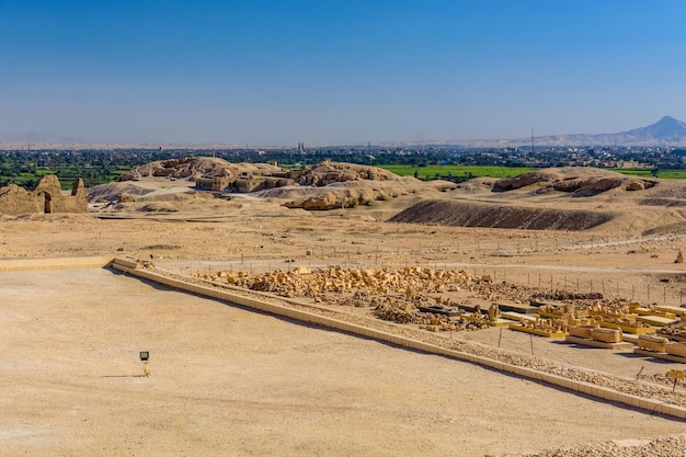 Archeological site near the temple of Hatshepsut in Luxor Egypt Green landscape on a background