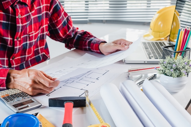 Architect concept. Architects man working with blueprints in the office.