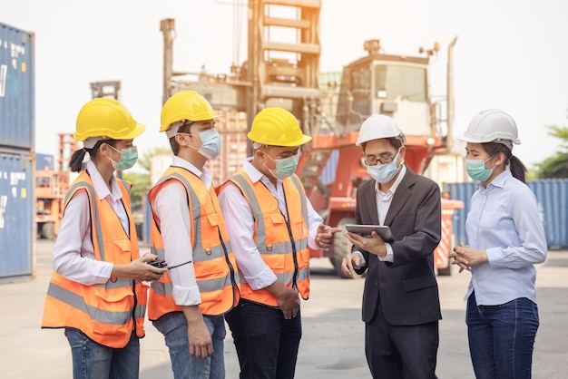 Architect of engineer and dock worker staff working checking at Container cargo harbor 