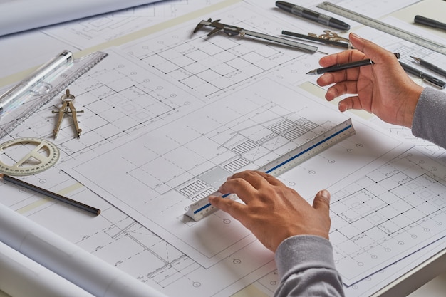 Architect engineer working blueprint in architect studio