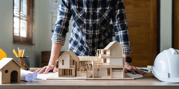 Architect man working with blueprints for architectural plan engineer sketching a construction project concept