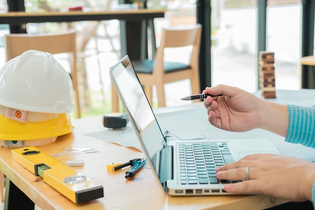 Architect or planner working on drawings for construction plans at a table