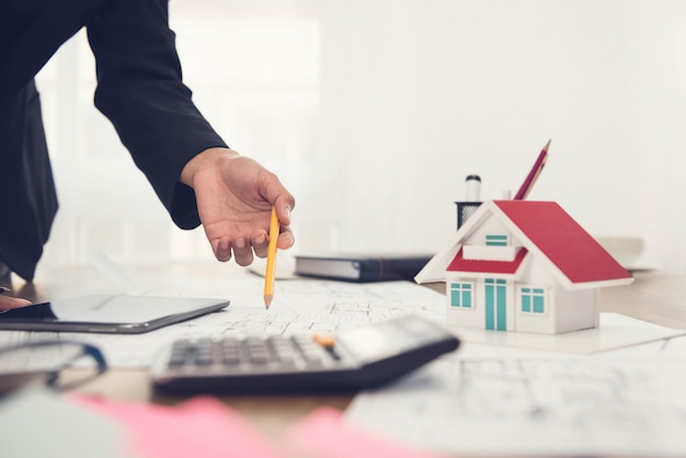 Architect working on a  house model