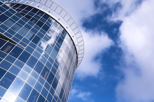 Architectural detail of the facade with multiple reflections of other buildings and the sun. Exterior of modern building. Architecture abstract background