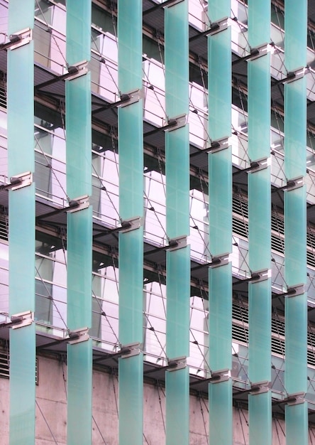 Architectural facade composed of greenish blue glass parasols