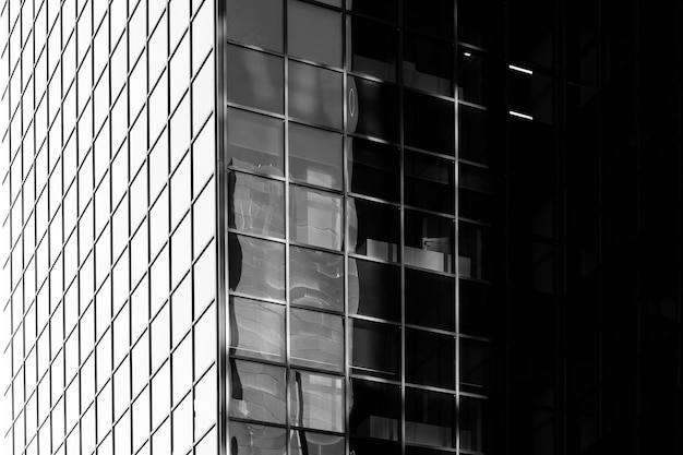 Architectural pattern on glass facÌ§ade with shadow gradient. Square glass window facade. Glass facade of office building