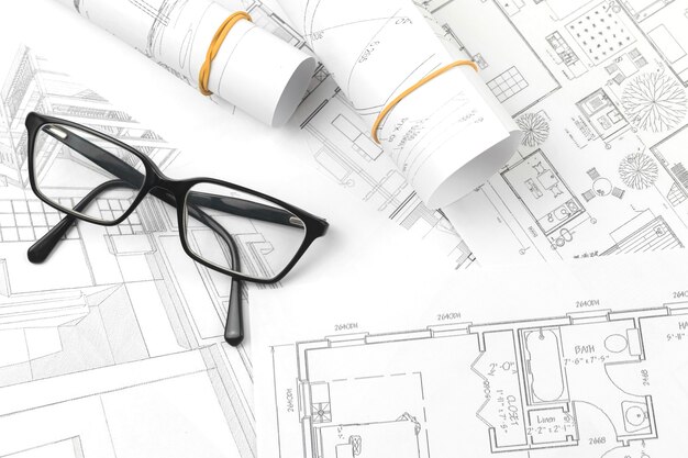 Architecture and engineering business concept background with blueprints and glasses, top view photo