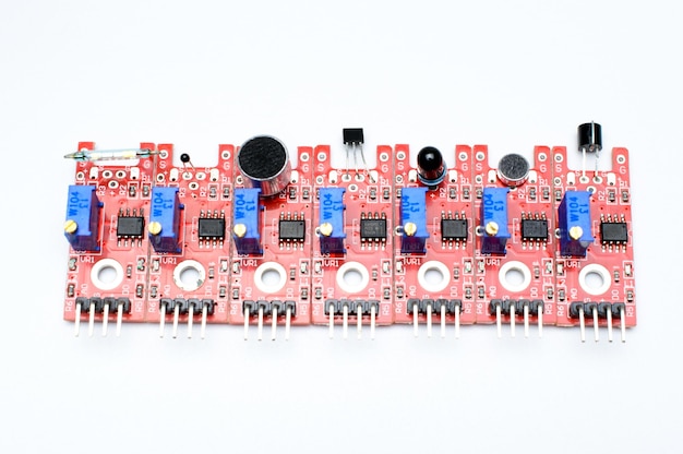 Photo arduino diy modules on a white background. selective focus. red pcb. blue potentiometers.