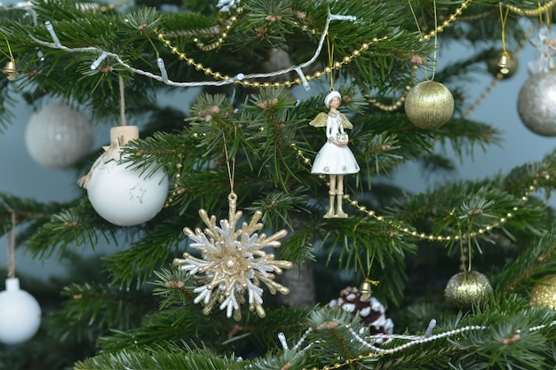 Argent gold and white and toys hanging on a Christmas tree