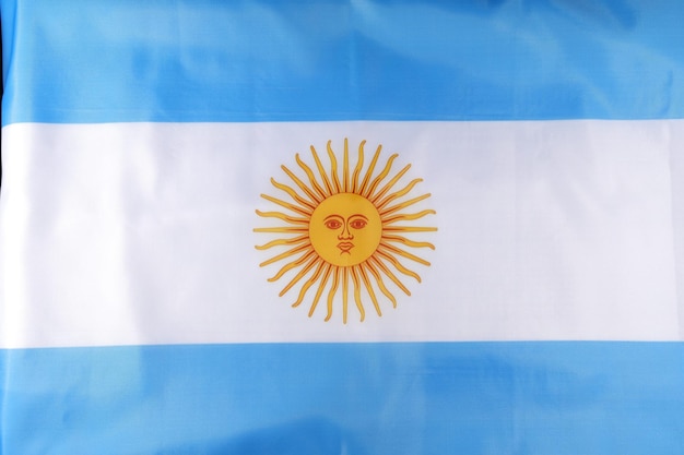 Photo argentinas national flag featuring the sun emblem displayed prominently against a blue and white