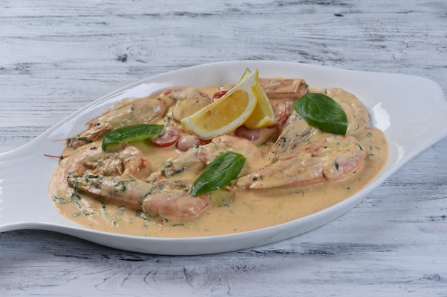 Argentine shrimp in a creamy sauce on a gray table. Background for the menu. top view