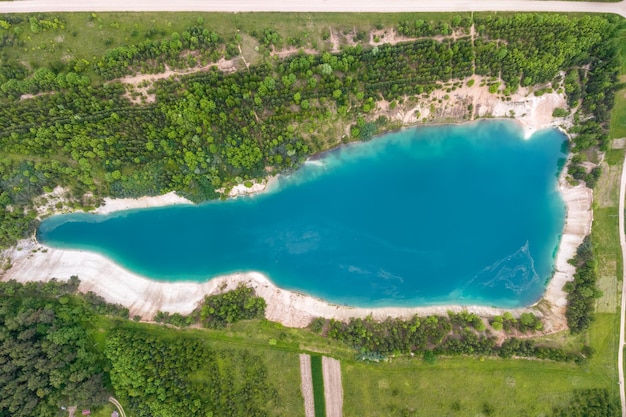 Ariel top view of an old flooded lime quarry with turquoise water