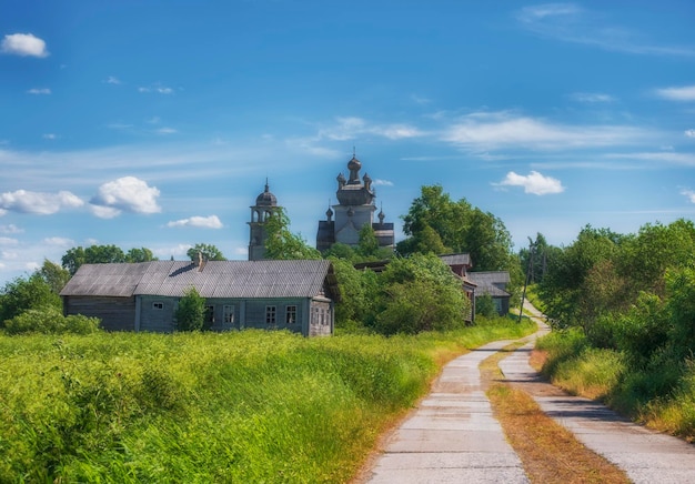 Arkhangelsk region the village of Turchasovo near the Onega River the old wooden Church of the Transfiguration of 1786 and the bell tower of 1793 rural road in vintage summer