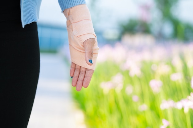 Arm splint, Injured female hand with lower body. Hand bandage with elastic fabric