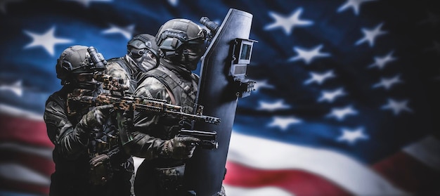 Armed special forces group on the background of the American flag War concept SWAT group Antiterrorism Release of the hostages Veteran's Day