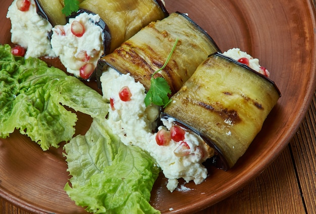 Armenian Eggplant Rolls, with Walnut and Pomegranate Stuffing, Armenian cuisine, Traditional assorted dishes, Top view.