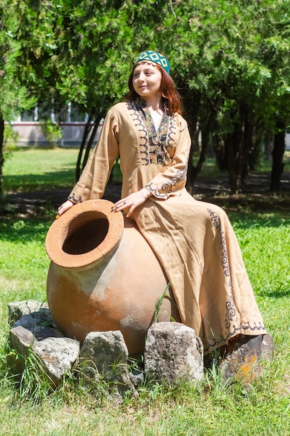 Armenian young woman in traditional clothes in the park woman with traditionnal clothes