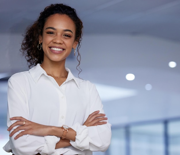 Arms crossed because Im the boss Shot of a young businesswoman standing with her arms crossed in an office at work