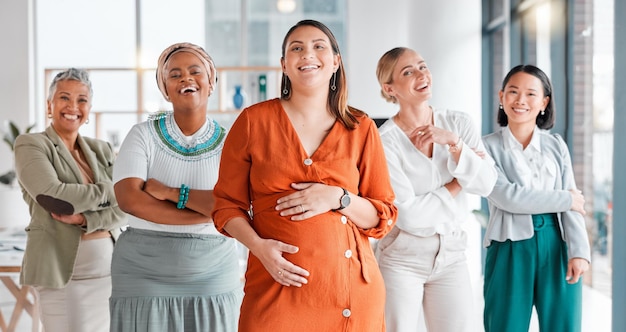 Arms crossed leadership and portrait of a pregnant woman with a team for diversity in the workplace Collaboration happy and women with pride and trust for teamwork and a manager during pregnancy