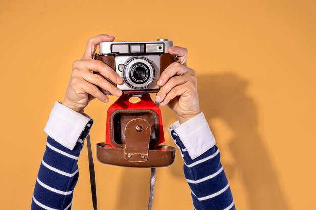 Photo arms up holding vintage camera isolated background