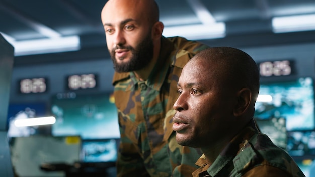 Army unit working in governmental facility next to colleague